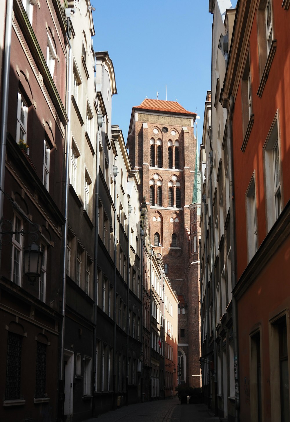 a narrow city street lined with tall buildings