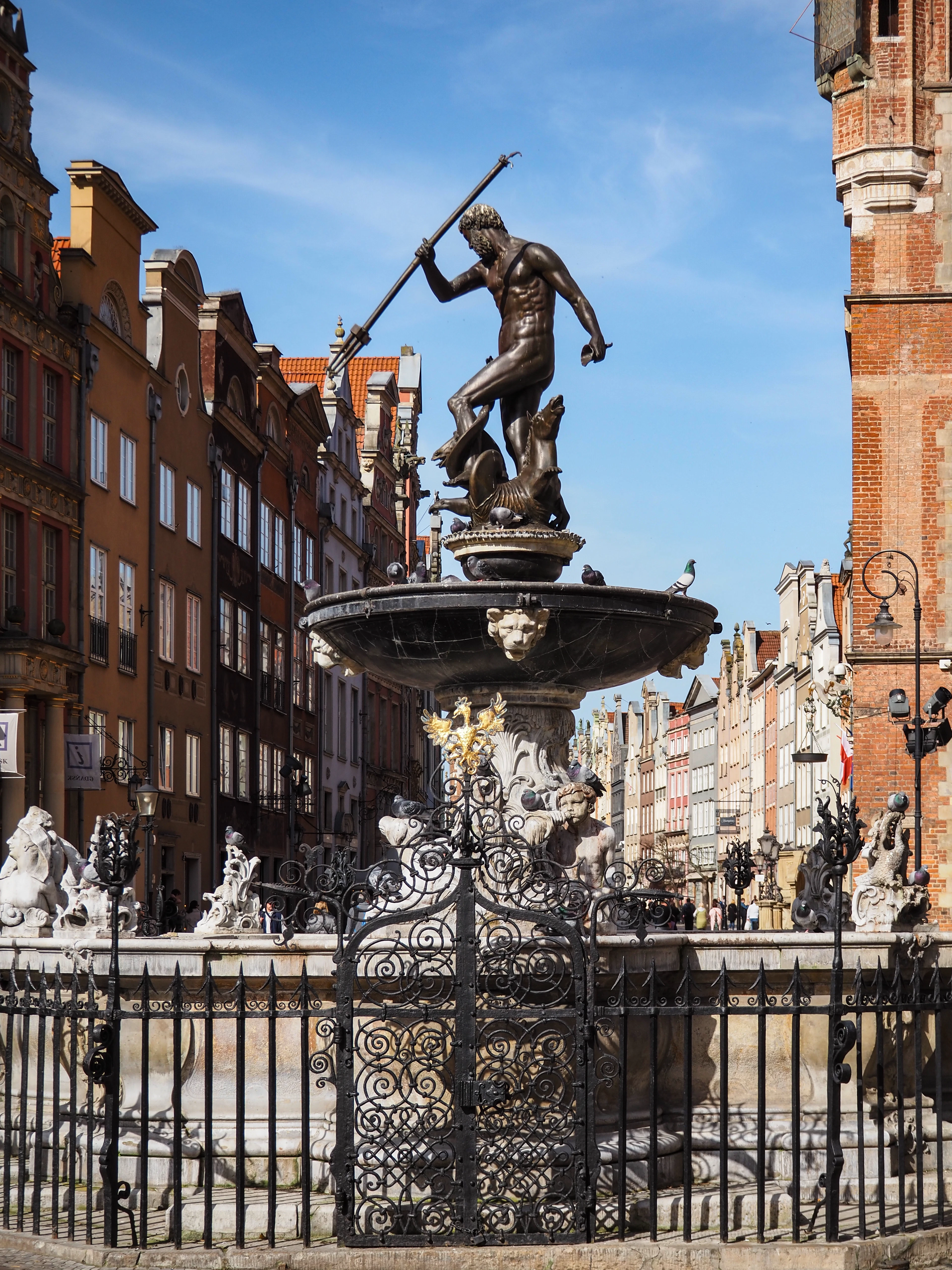 The Neptune Fountain on Gdansk's Long Market, its bronze figure raised above the wrought-iron screen