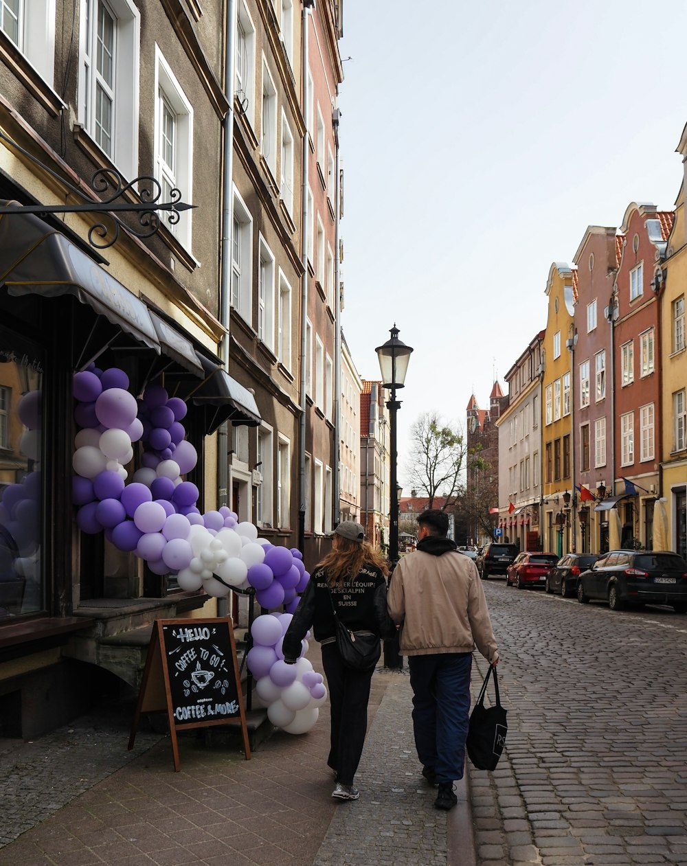 a couple of people walking down a street