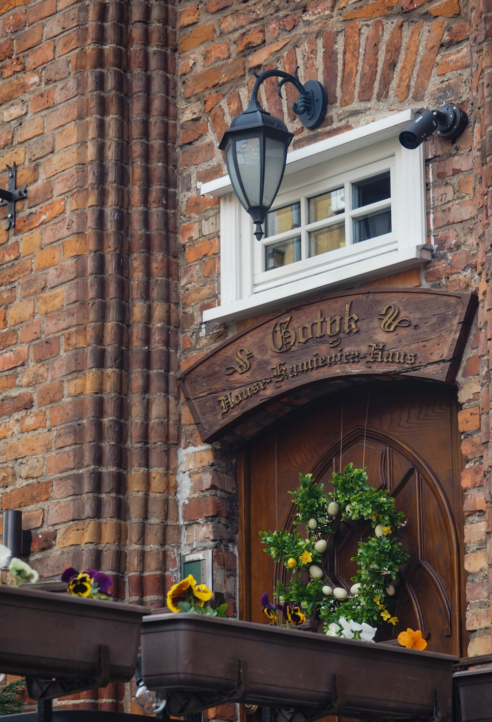 a brick building with a wreath on the front of it