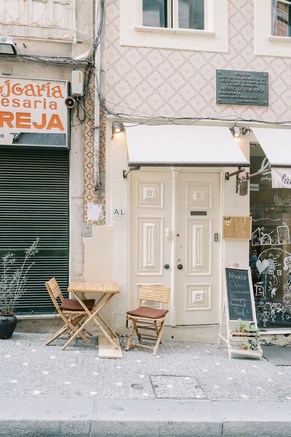 a couple of chairs sitting outside of a building