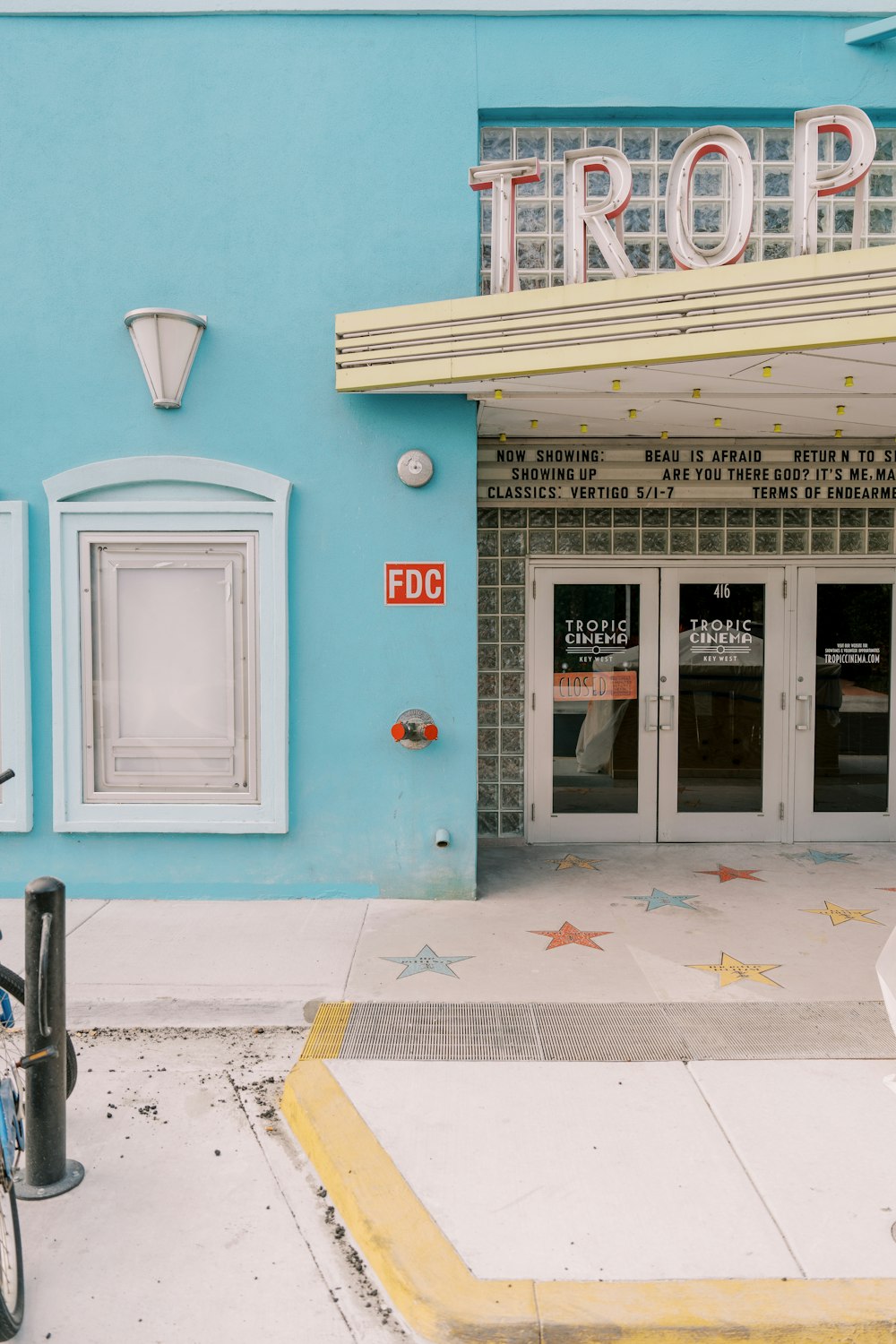 a bicycle parked in front of a movie theater