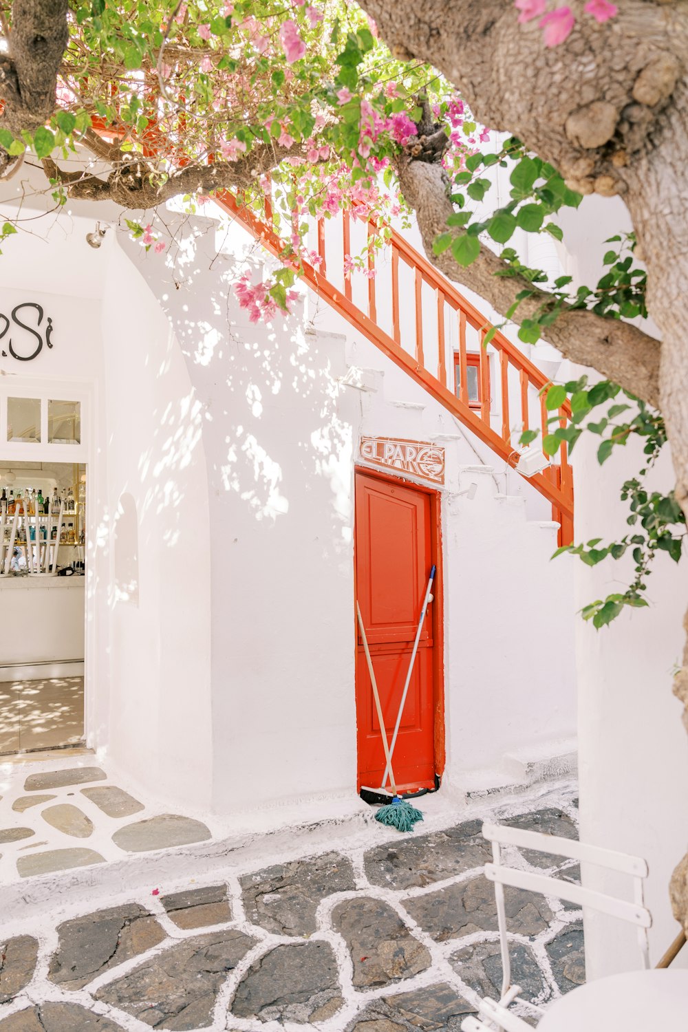 a red door on the side of a white building