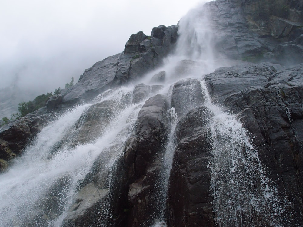 a very tall waterfall with lots of water coming out of it