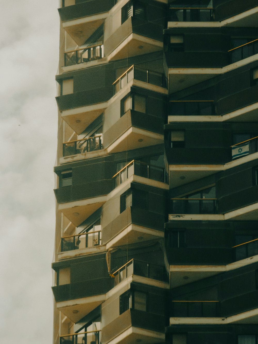 a tall building with balconies on the top of it