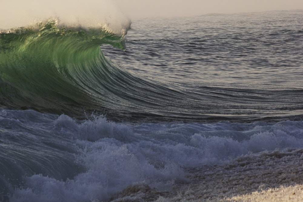 a large wave is coming towards the shore