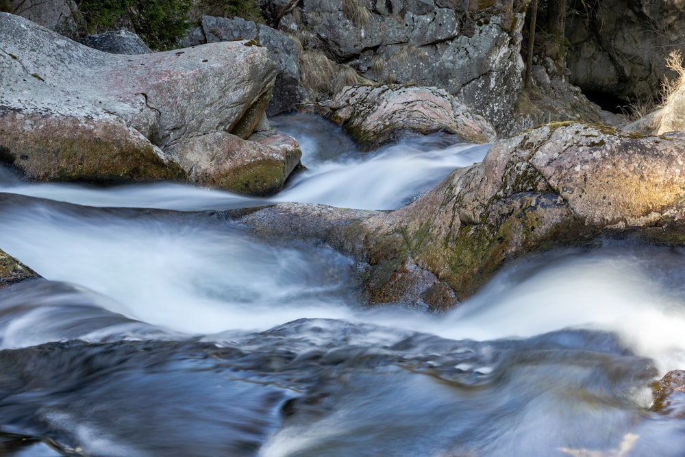 a stream of water running between some rocks