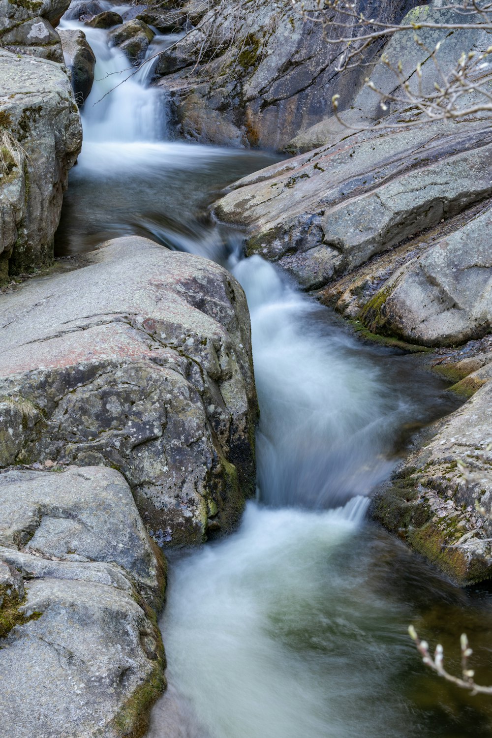 a stream of water running between two large rocks