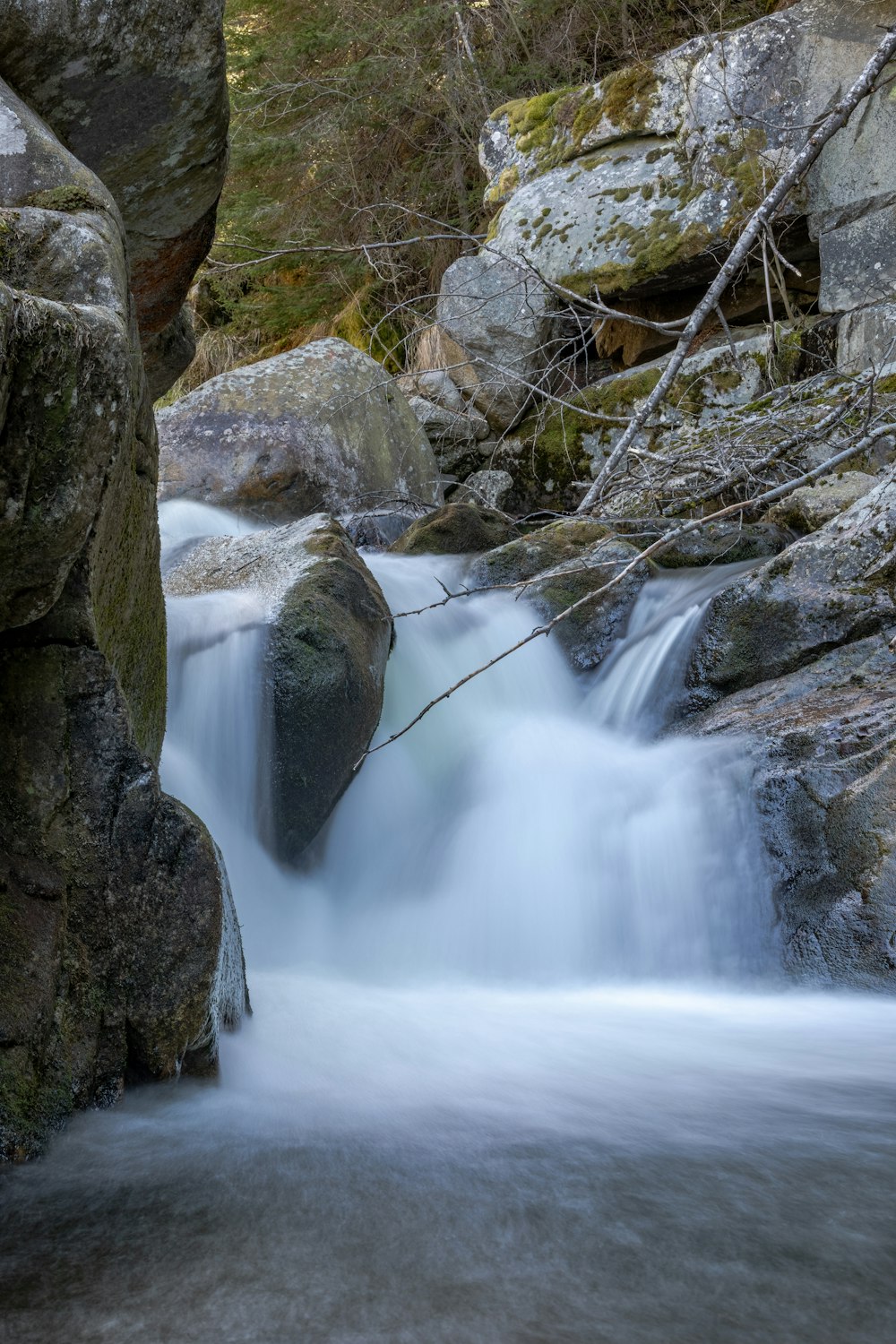 a stream of water running between two large rocks
