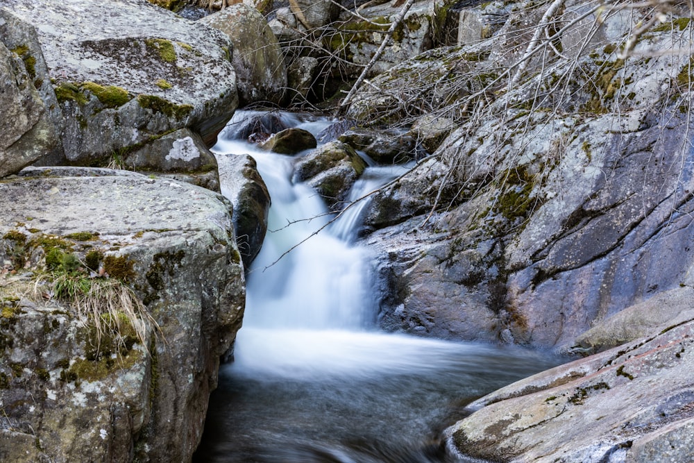 a stream of water running between two large rocks