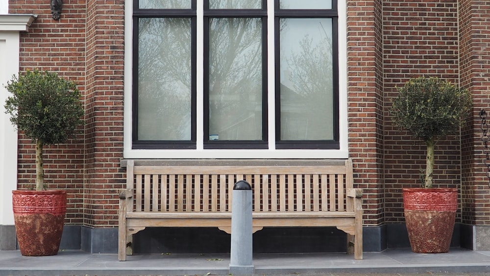 a wooden bench sitting in front of a building