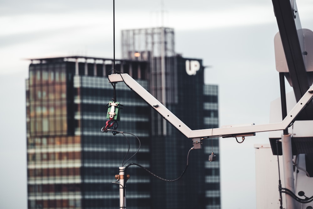 a crane is lifting a piece of metal into the air