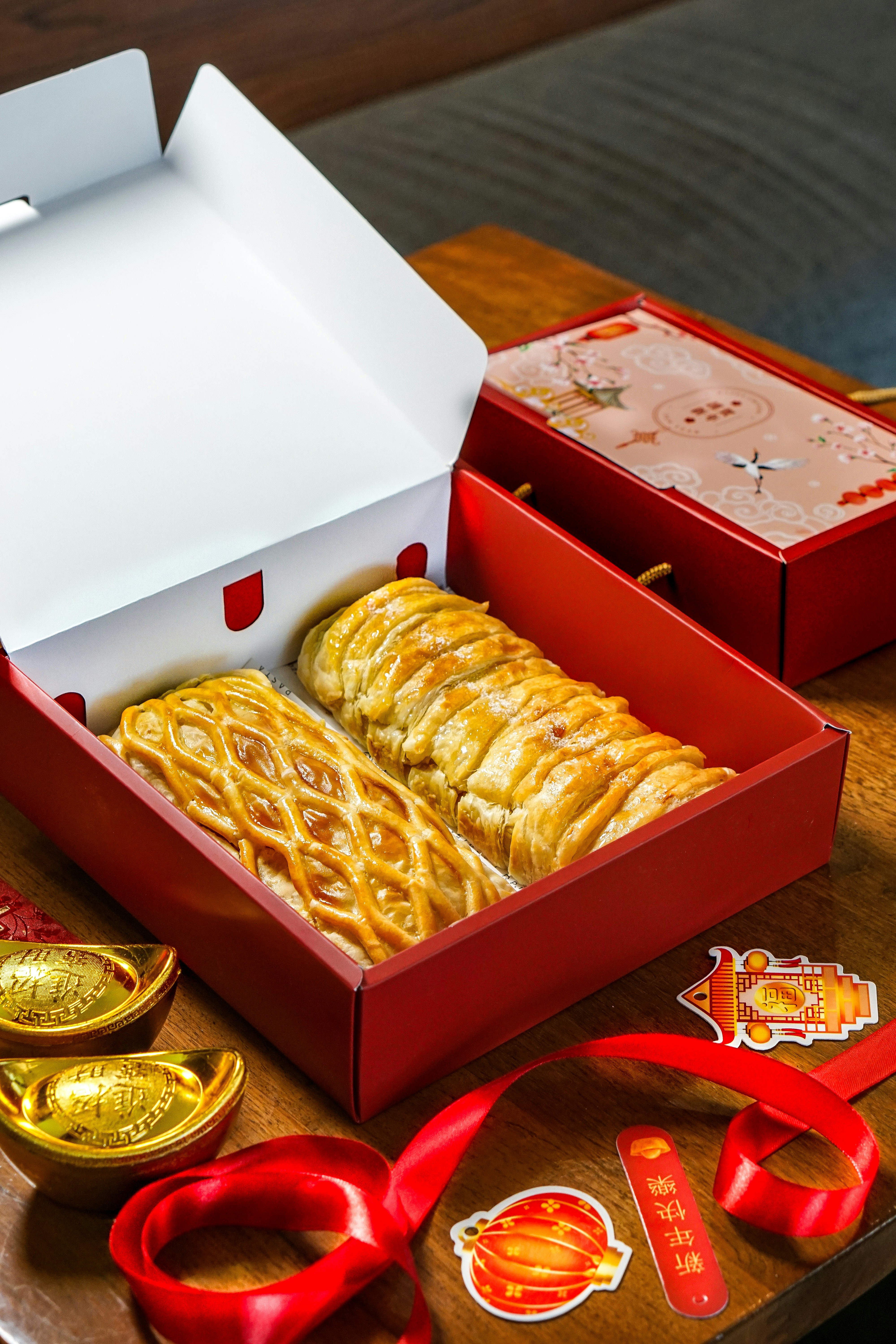 a red box filled with lots of food on top of a table