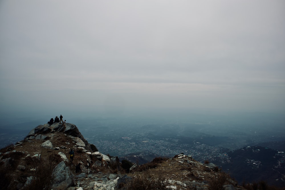 a group of people sitting on top of a mountain