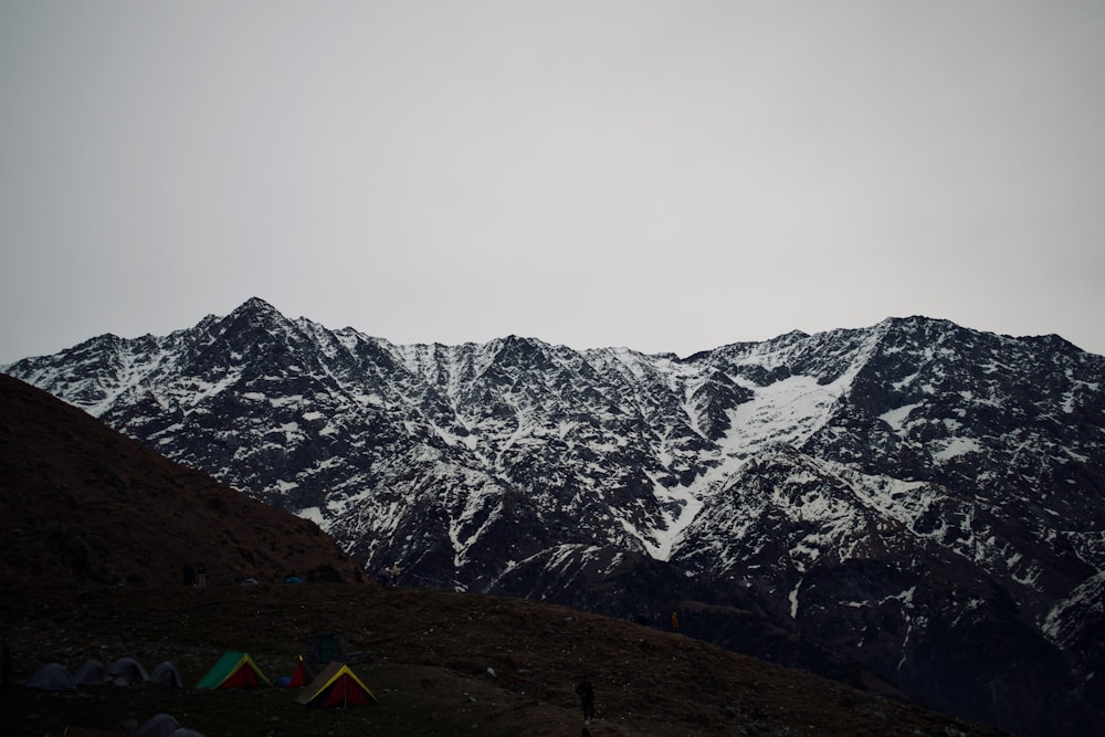 a group of tents pitched up in the mountains