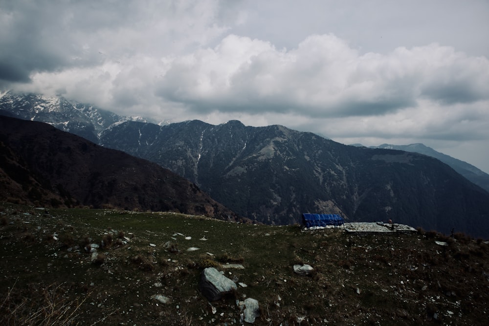 a view of a mountain range from the top of a hill