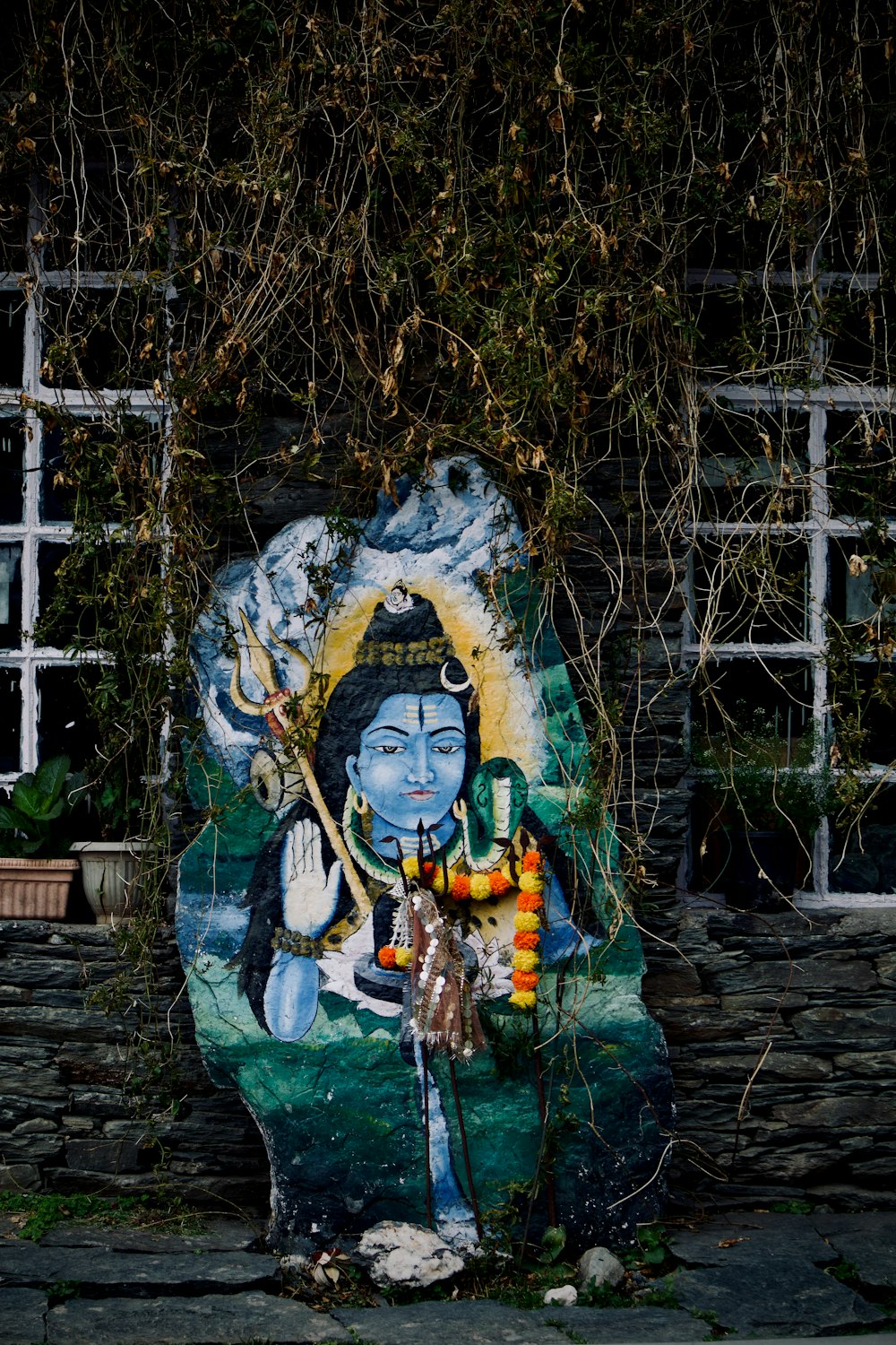 a painting of a buddha on a stone wall
