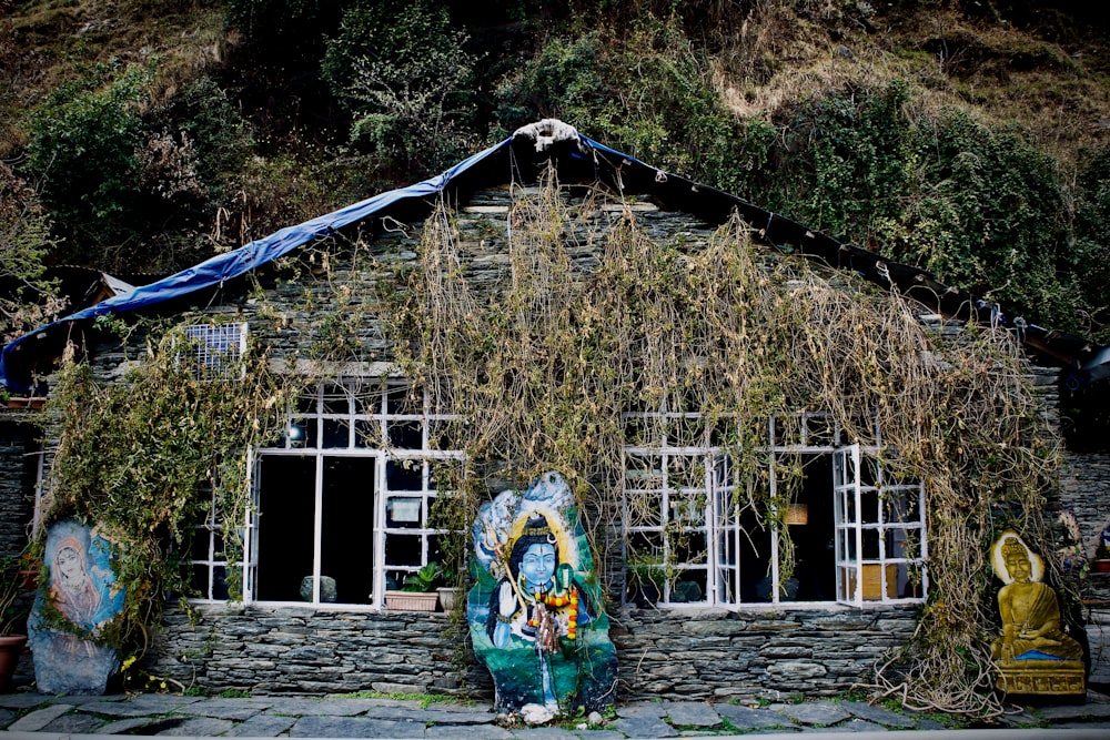 a stone house with vines growing over it