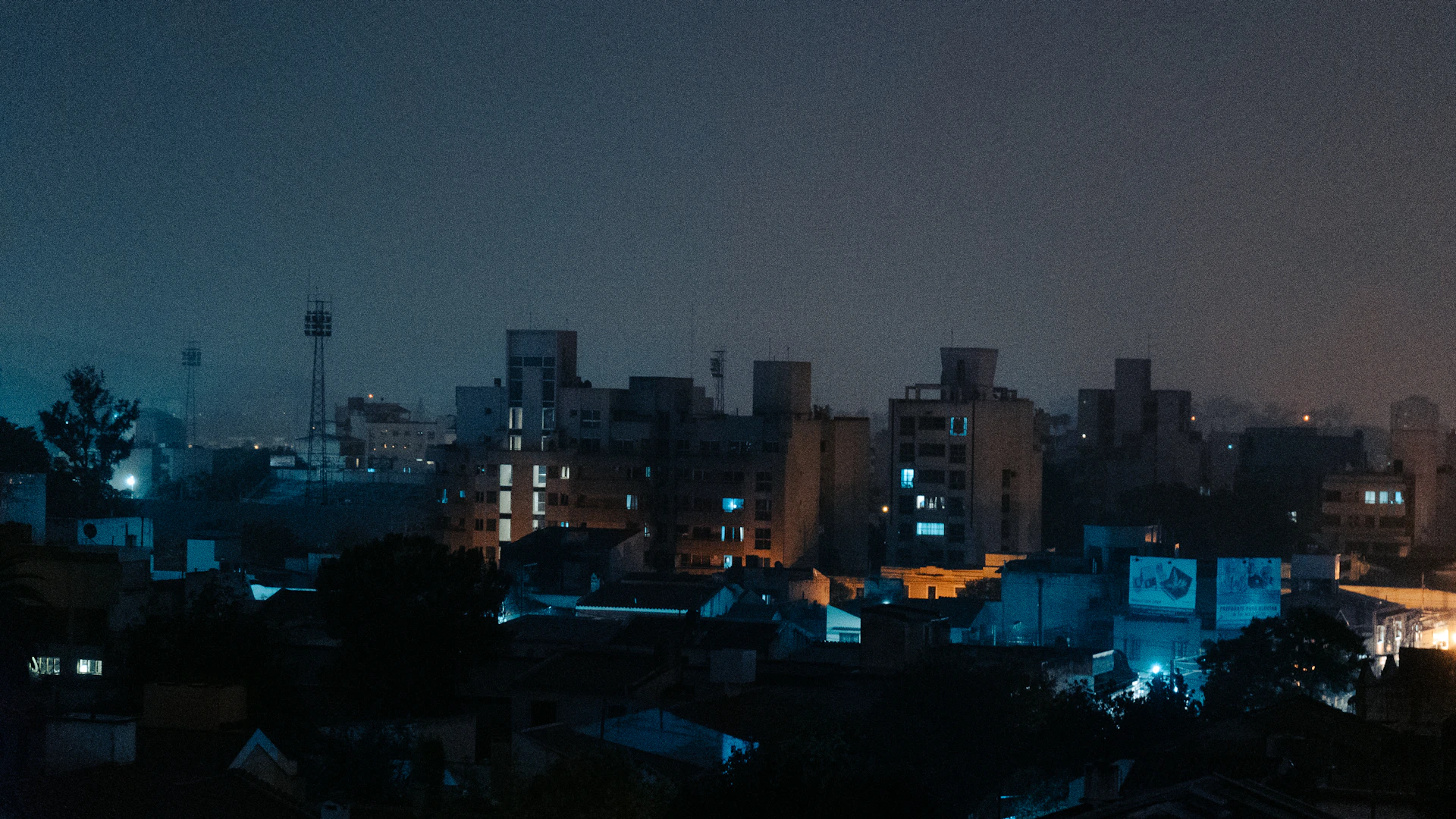 a city skyline at night with buildings lit up