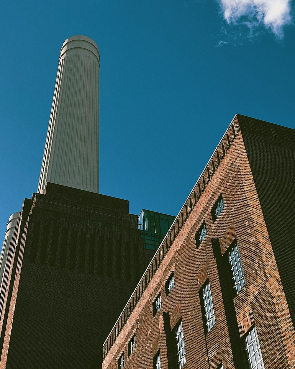 a tall brick building with a clock tower in the background