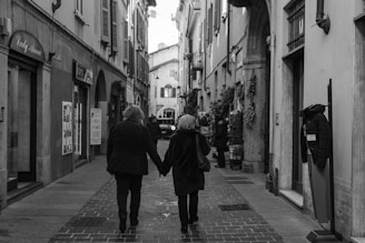 a couple of people that are walking down a street