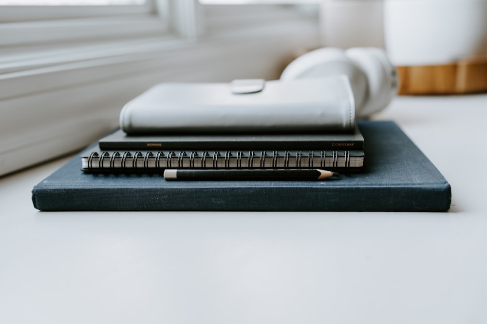 a stack of books sitting on top of a table