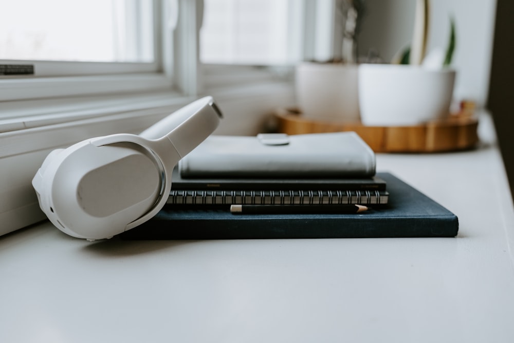 a pair of headphones sitting on top of a book