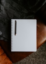 a notebook with a pen on top of it