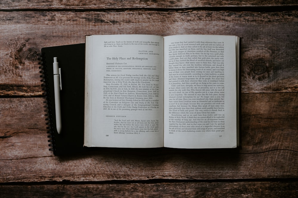 an open book sitting on top of a wooden table