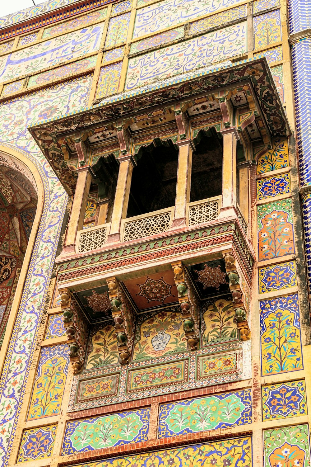 a colorful building with a clock on the side of it