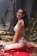 a woman in a bikini sitting on a towel