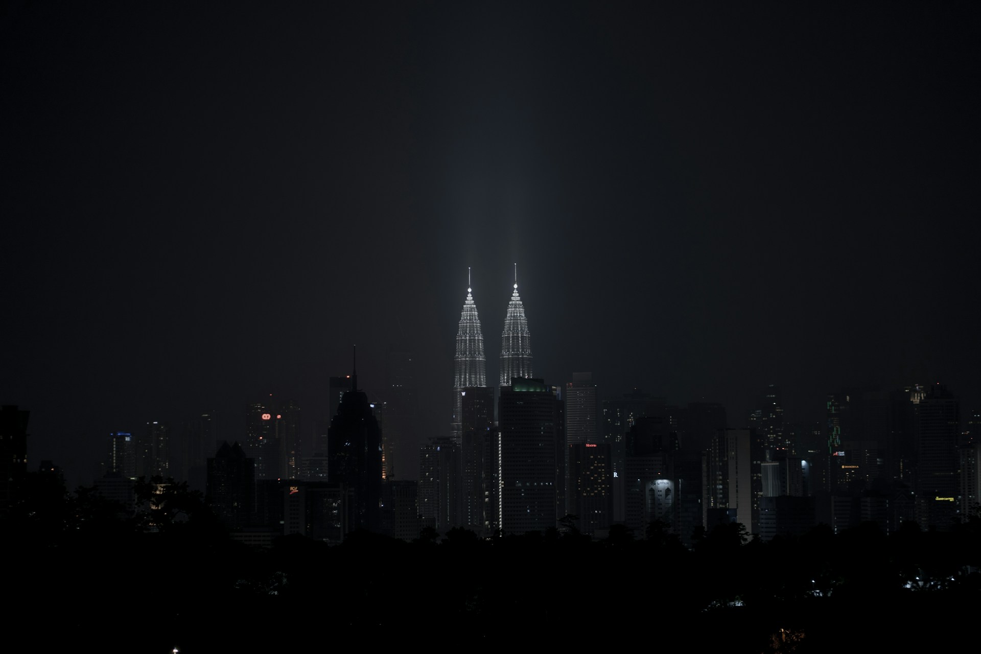 a city at night with a very tall building