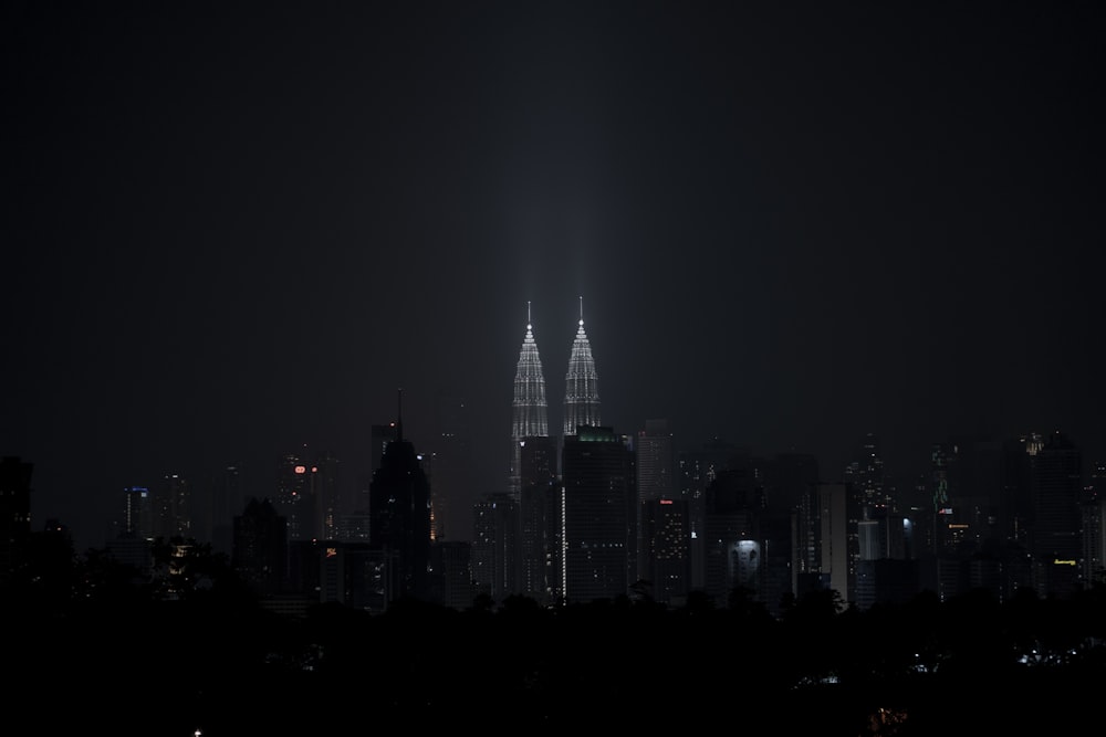 a city at night with a very tall building