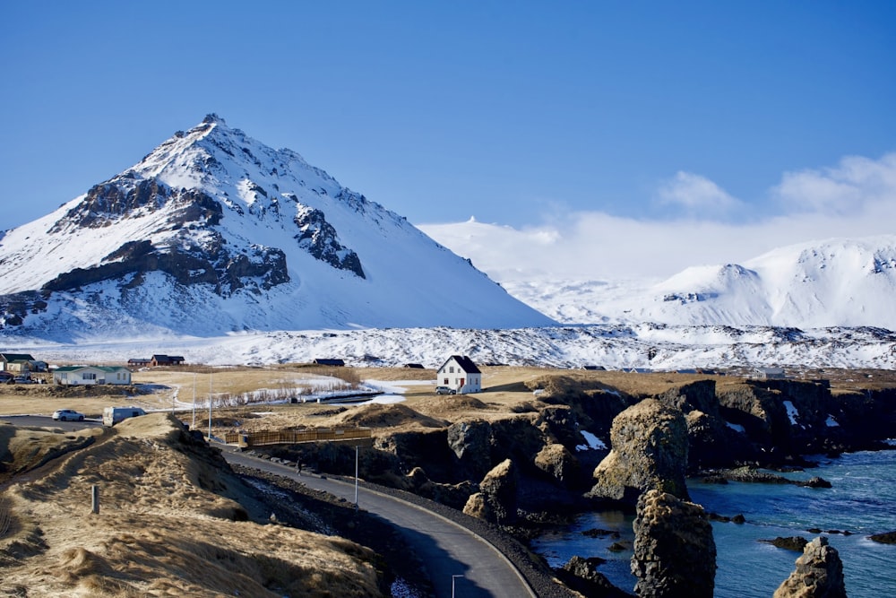 a snow covered mountain with a road going through it