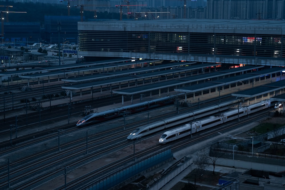 a train station with multiple trains on the tracks