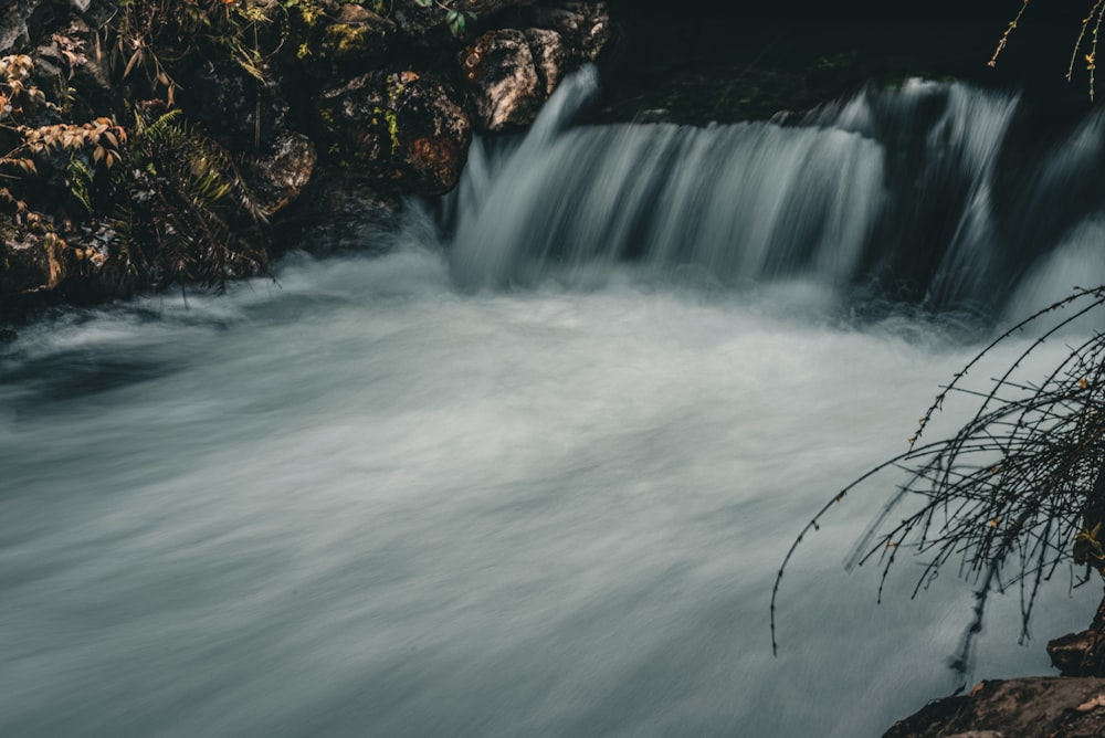 a small waterfall in the middle of a river