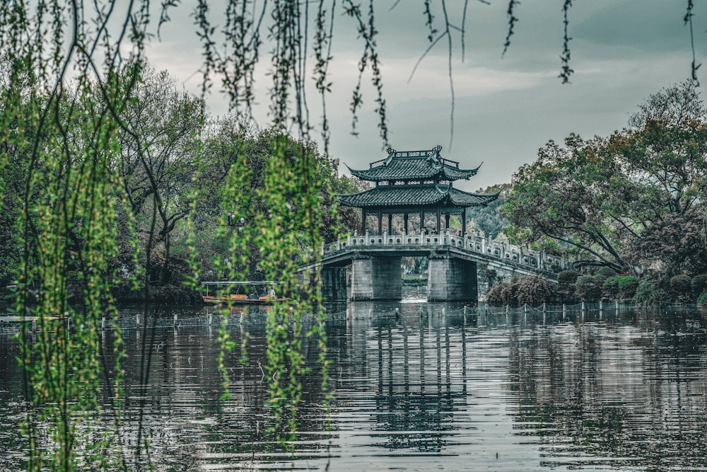 a bridge over a body of water surrounded by trees