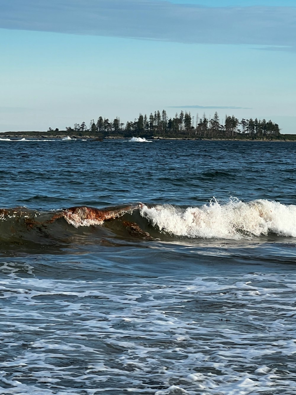 a man riding a wave on top of a surfboard