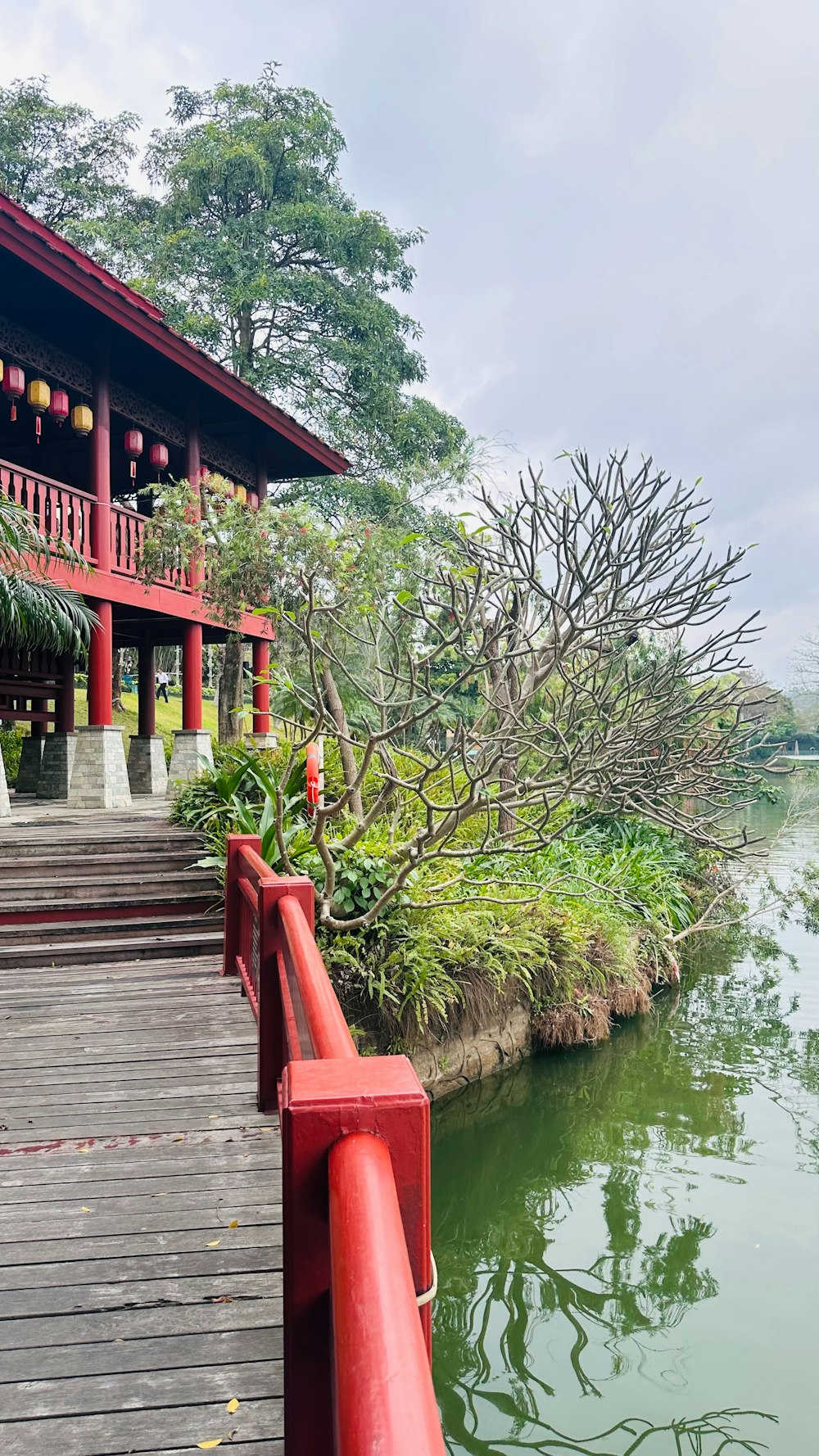 a red bridge over a body of water