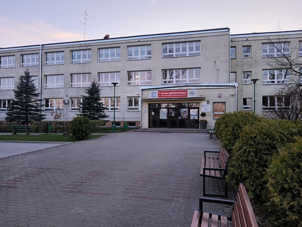 a building with a lot of windows and a bench in front of it