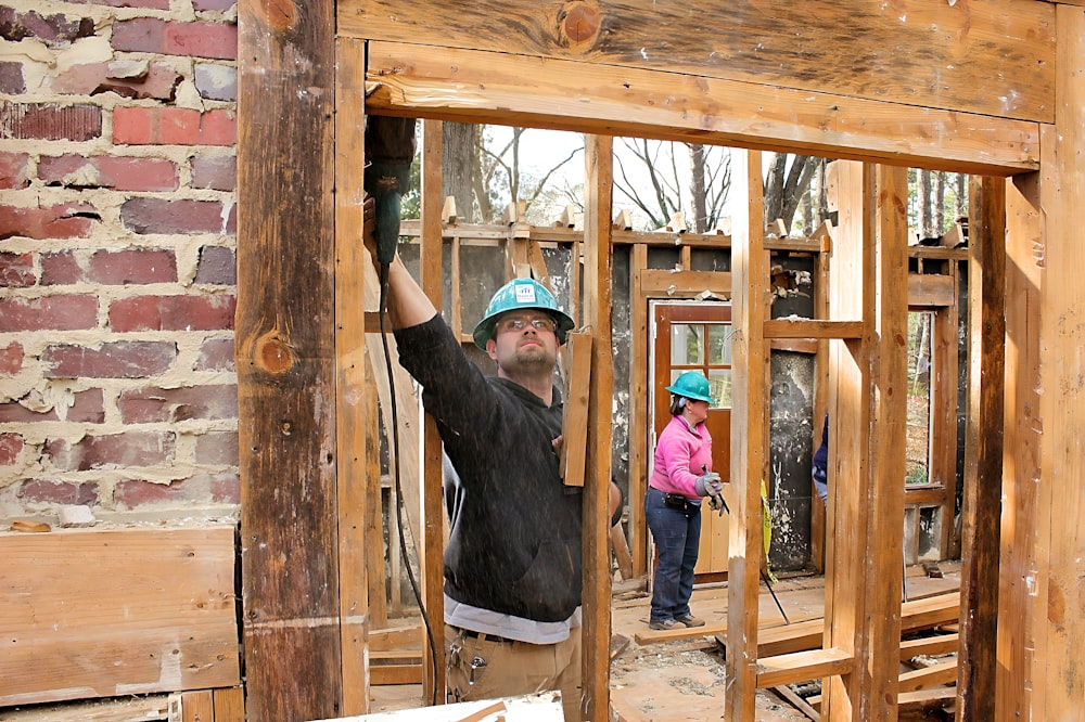 a man standing inside of a house under construction