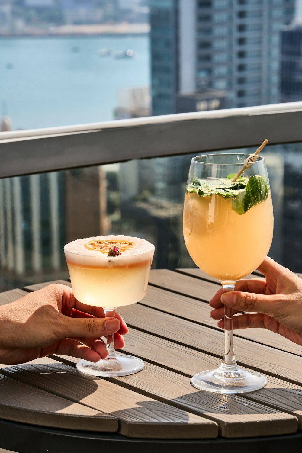 a couple of people holding glasses of drinks