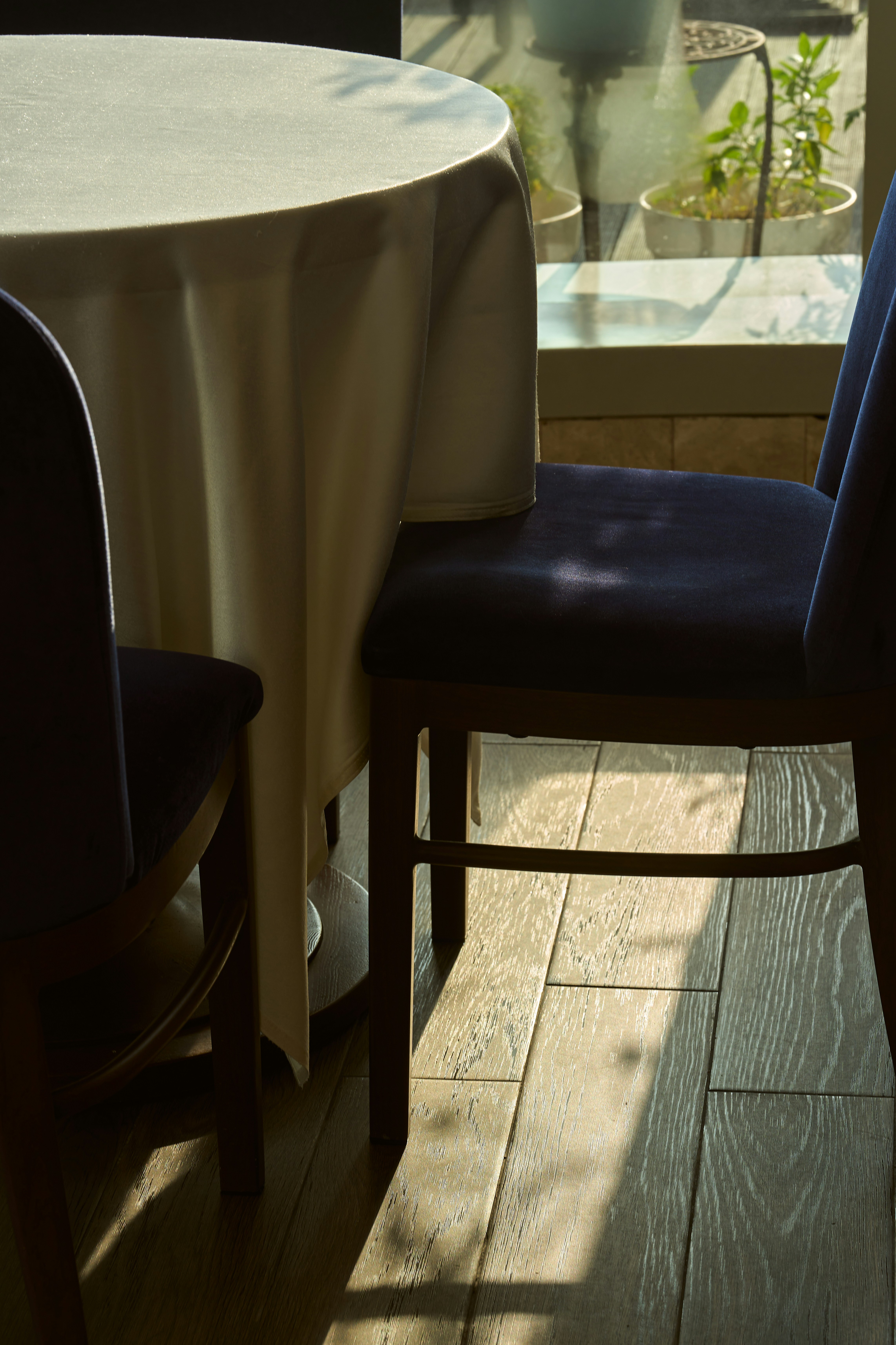 a table with a white table cloth and a blue chair