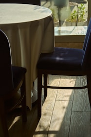 a table with a white table cloth and a blue chair