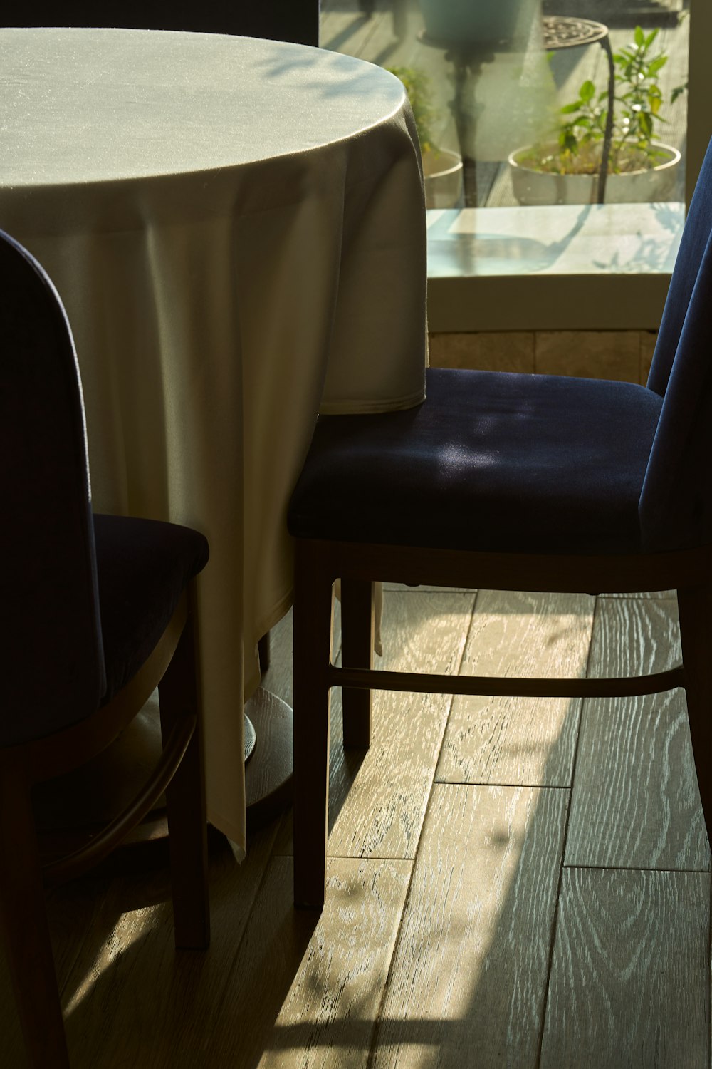 a table with a white table cloth and a blue chair