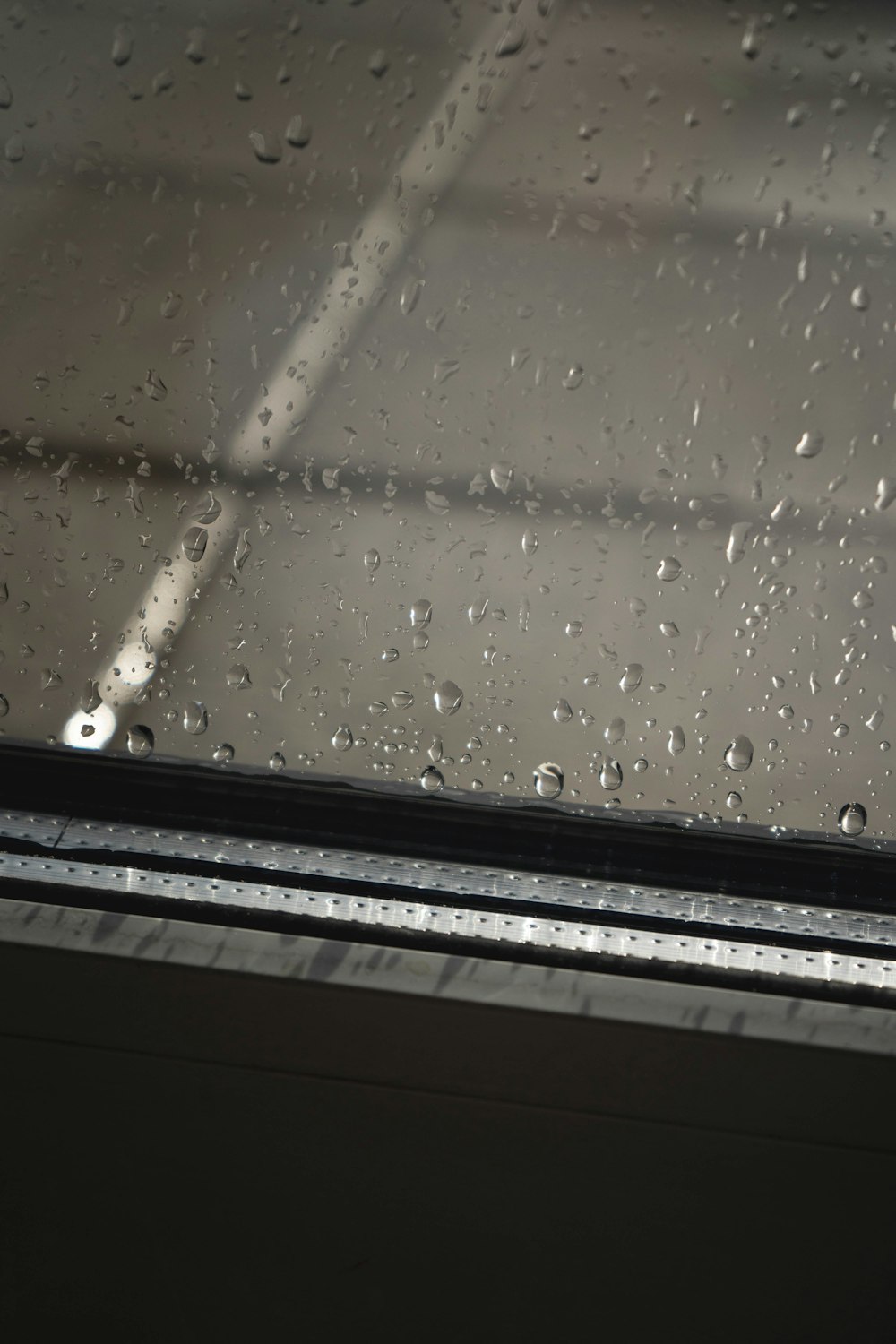 a window with rain drops on the glass