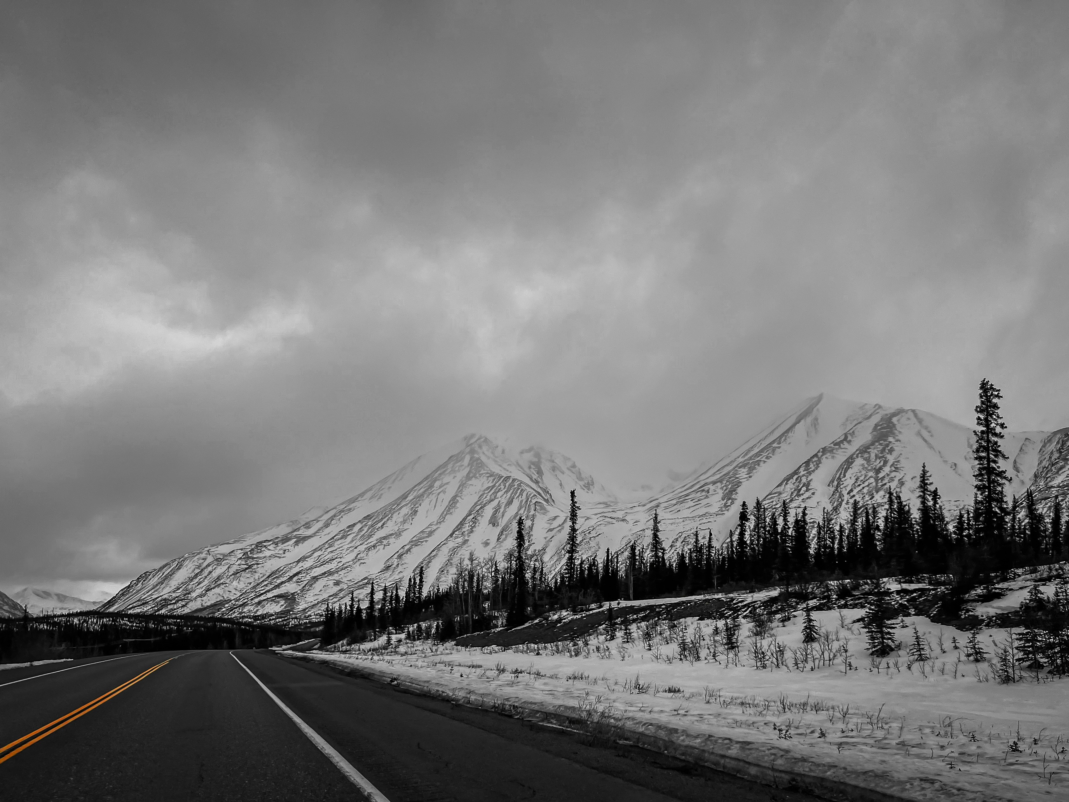a black and white photo of a snowy mountain, 