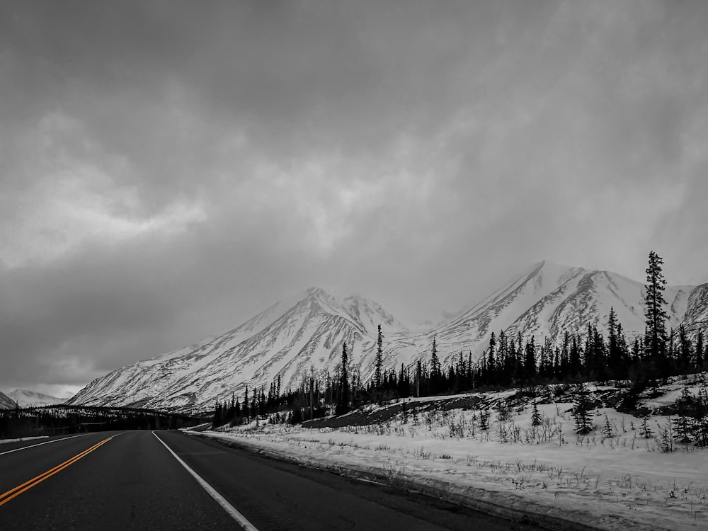 a black and white photo of a snowy mountain