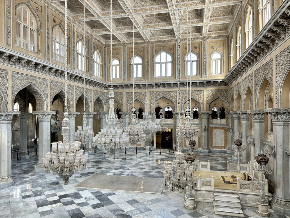 a large room with a checkered floor and chandelier