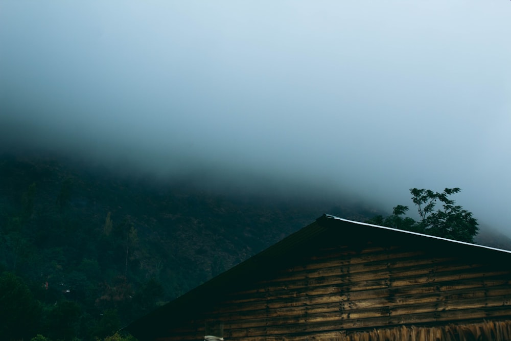 a wooden cabin with a mountain in the background